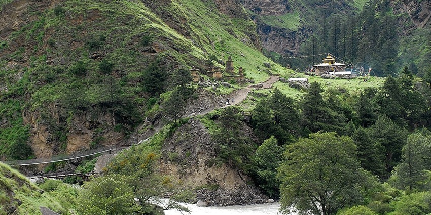 A distant temple in the Mugu region with traditional architecture near Rara Lake in Nepal.