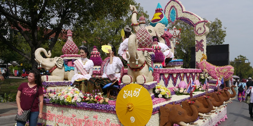 Colorful floral float with traditional Thai dancers at Chiang Mai Flower Festival