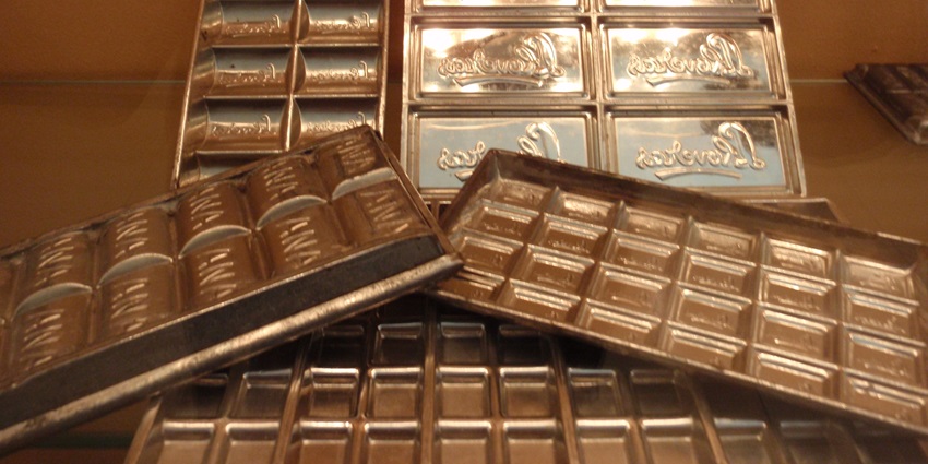 Antique chocolate moulds showcasing intricate designs from a historic chocolate museum.