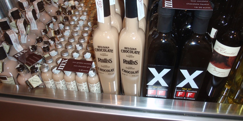 An elegant display of chocolate treats, rich sauces, and fine wines at a chocolate museum.