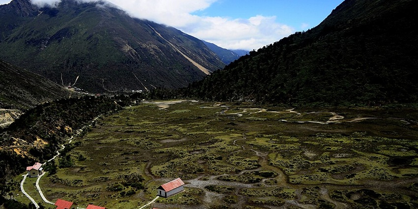 A wide view of the valley on a sunny day in Chopta Valley near Gurudongmar Lake in Sikkim