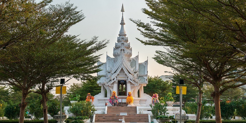 Tree-lined walkway leading to the north facade of the City Pillar Shrine in Phayao