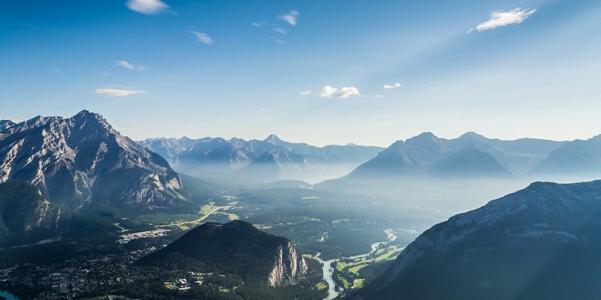 Mist is gently settling over the mountains while rivers are winding through valleys