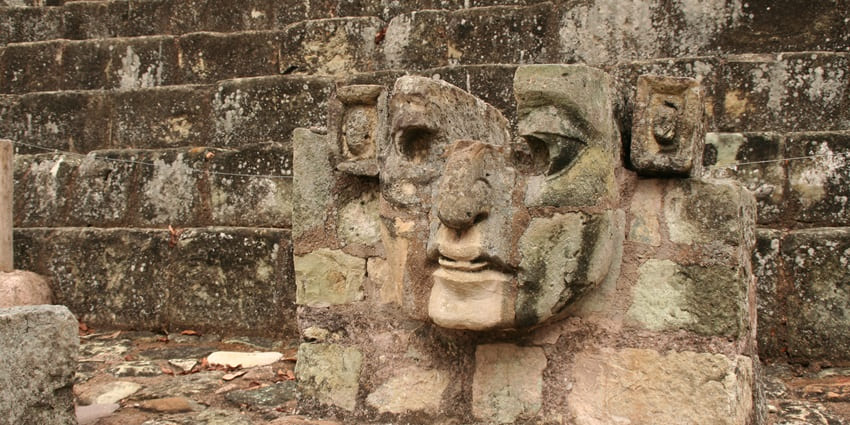 A detailed Mayan stone carving in Copán Ruinas showcasing intricate glyphs and figures.