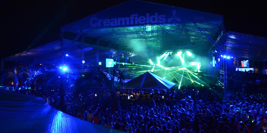 A view of the entire stage and the crowd grooving to the music at the music festival.
