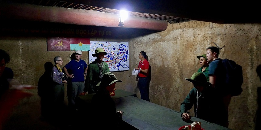 An image of tourists crawling through the Cu Chi tunnels, a place near Ho Chi Minh City.