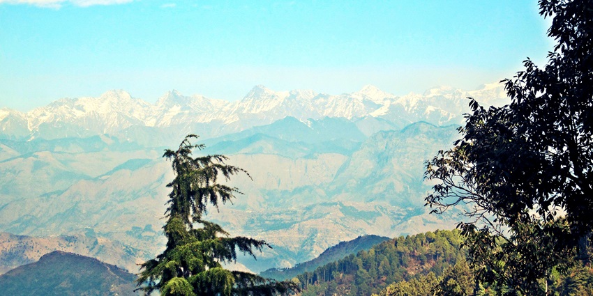 Dalhousie Hill station from above with lush green trees and majestic snow mountains