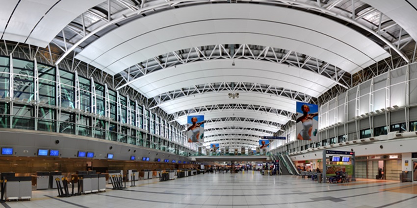 The aerial view of a modern airport terminal building equipped with essential amenities.