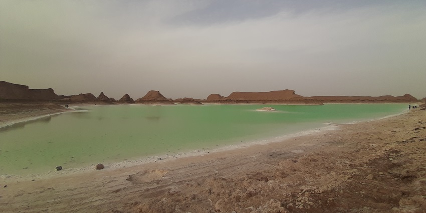 Desert with rugged ranges and varied terrain hues at the Dasht-e Lut Desert, Iran.