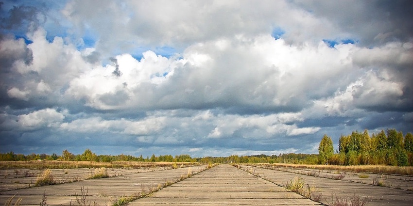 Daugavpils International Airport runway stretches under the cloudy sky in Latvia.