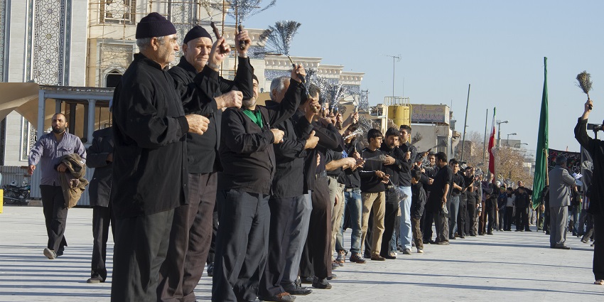 An image showing people participating in a religious procession during the act of Muharram.
