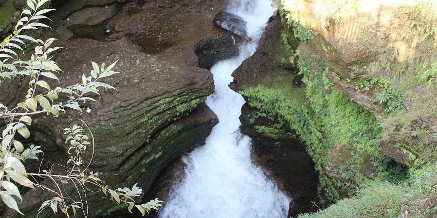 Devil’s Fall in Pokhara, Nepal, showcasing a powerful waterfall surrounded by rocky cliffs