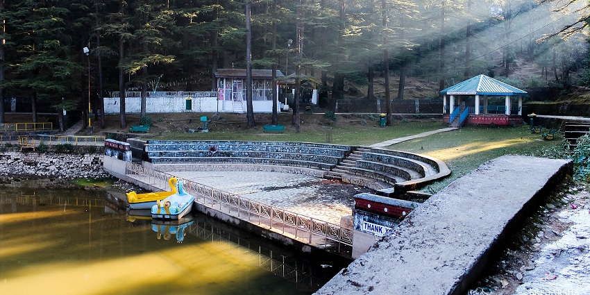 Sriharsa dal lake with a green water body, two boats in the lake and round stairs