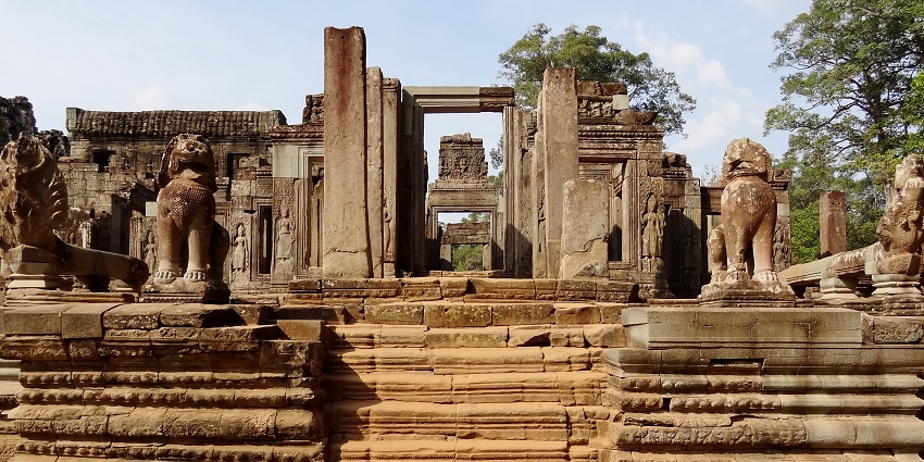 The Angkor Thom Bayon temple featuring carved stairs and, lion statues.