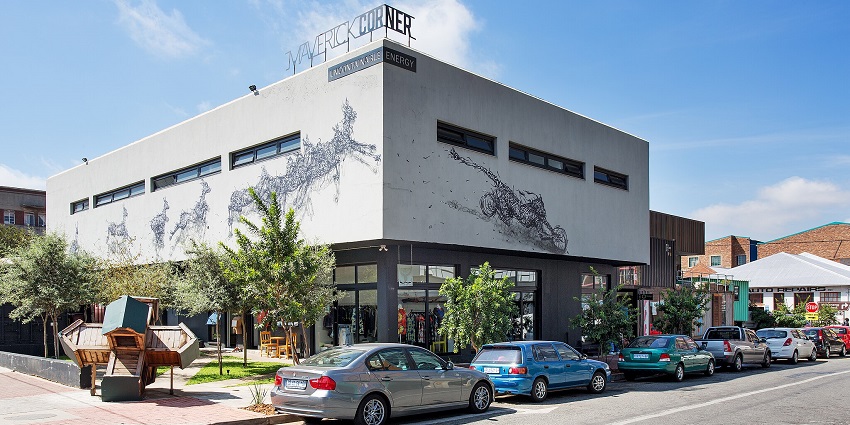 An image of the Maboneng Precinct with a festive atmosphere and a colourful mascot.