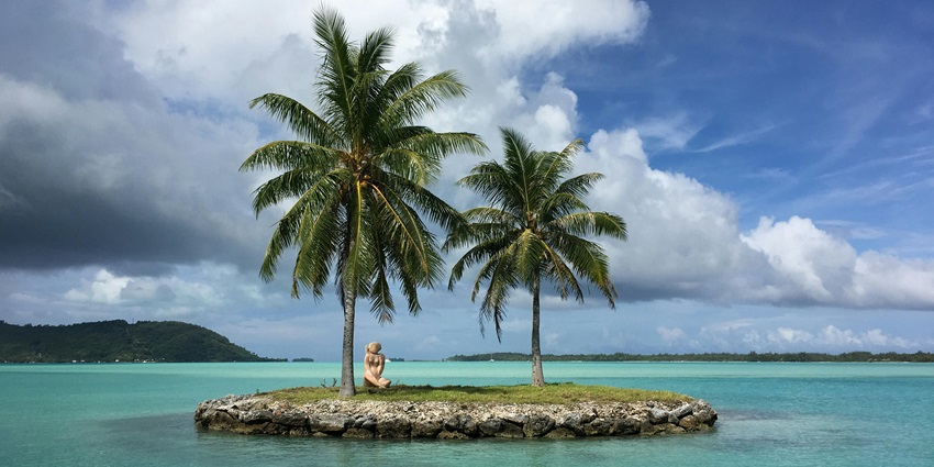 A pristine beach on Rumung Island, surrounded by lush vegetation and turquoise waters.
