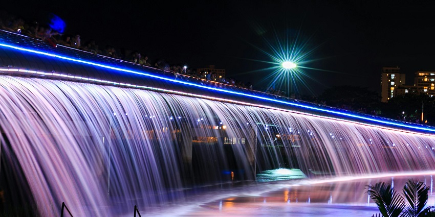 An image showing a LED water fountain at night, similar to District 7 and Starlight Bridge.
