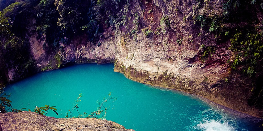An image of the tranquil turquoise pools and cascading waterfalls of Bassin Bleu, one of the top things to do in Haiti.