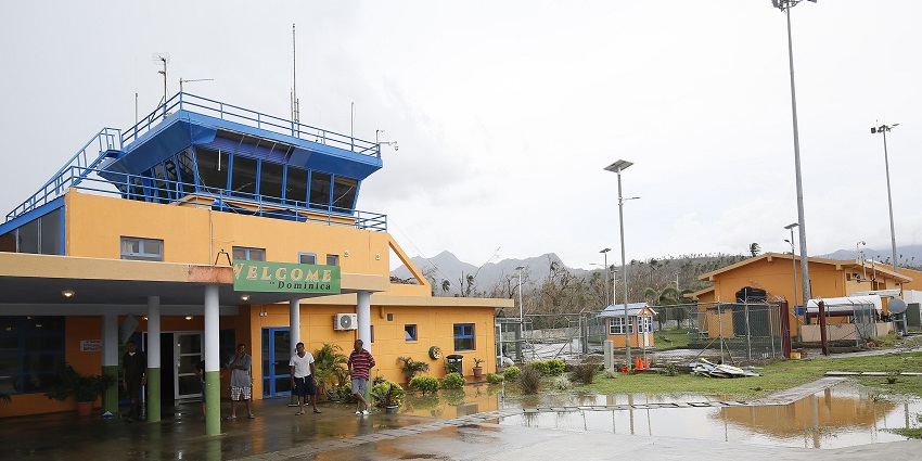 The main terminal of Douglas-Charles Airport, with a sign that says “Welcome to Dominica”