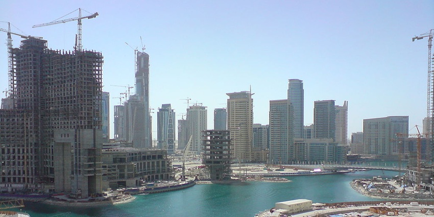 A vibrant waterfront with luxury yachts, skyscrapers, and lively nightlife
