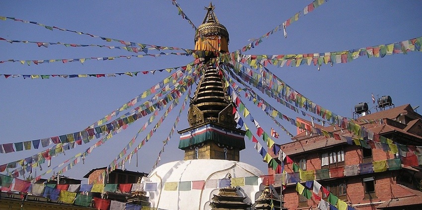 An image showing a sunset over a stupa with Buddhist elements, similar to Dungtse Lhakhang.
