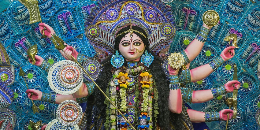 An image of a colourful, ornate statue of Goddess Durga, during Durga Ashtami celebrations