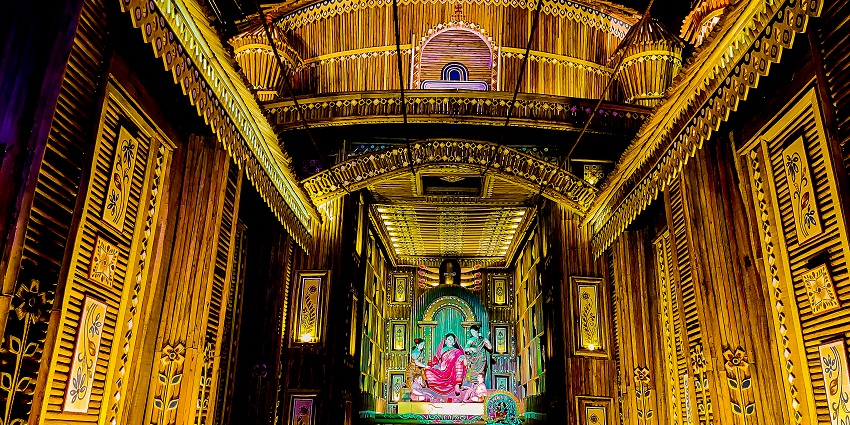 An image of a detailed Durga idol with intricate white decorations, during Durga puja in West Bengal.