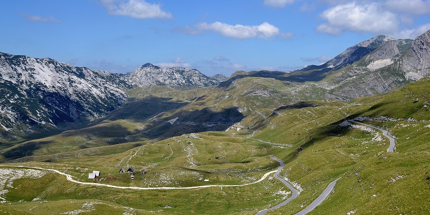 A breathtaking view of the trails of the Durmitor mountains amidst the grassland
