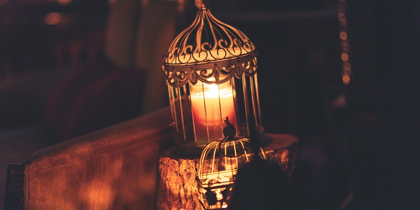 An image showing a brown metal cage with a lighted candle during Eid-al-Adha celebrations