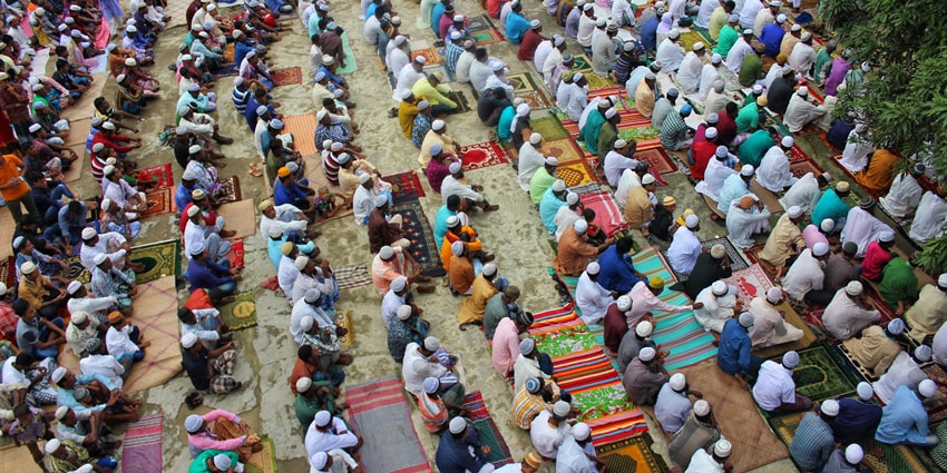 An image of muslims after offering Eid prayers, serving sweets and Arabic food as they celebrate Eid al-Adha.