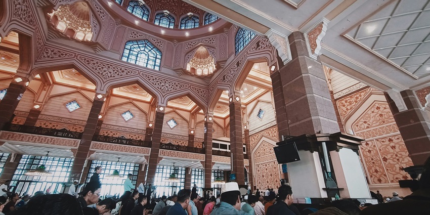 A large group of Muslim worshippers gathered inside the Mosque showcasing the congregation's devotion