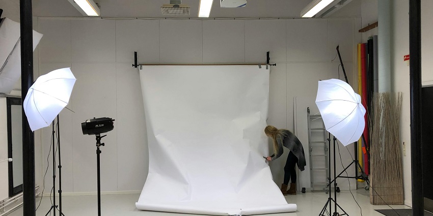 A well-lit art studio with mannequins, sewing materials, and design tools