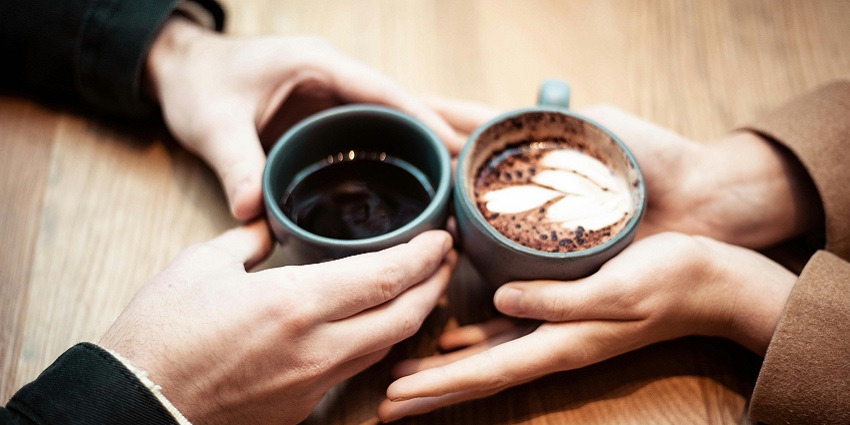 A Couple enjoying coffee at a rooftop café with panoramic views of Ho Chi Minh City.