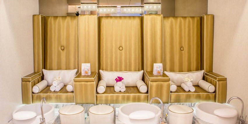 An image of spa essentials, including oils and powders, arranged neatly with a decorative flower present.