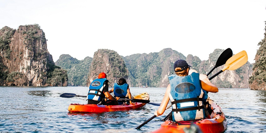 Things to do in Railay Beach involve paddling a kayak along towering limestone formations.