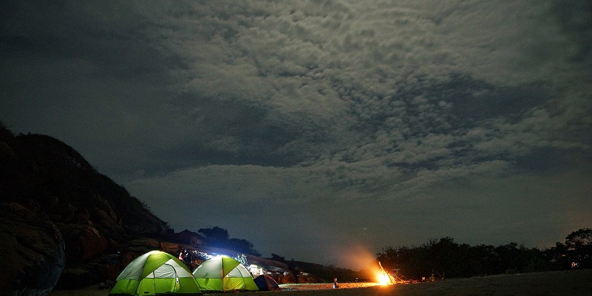 An image of some tents at a camping site in Kumana National Park at night.