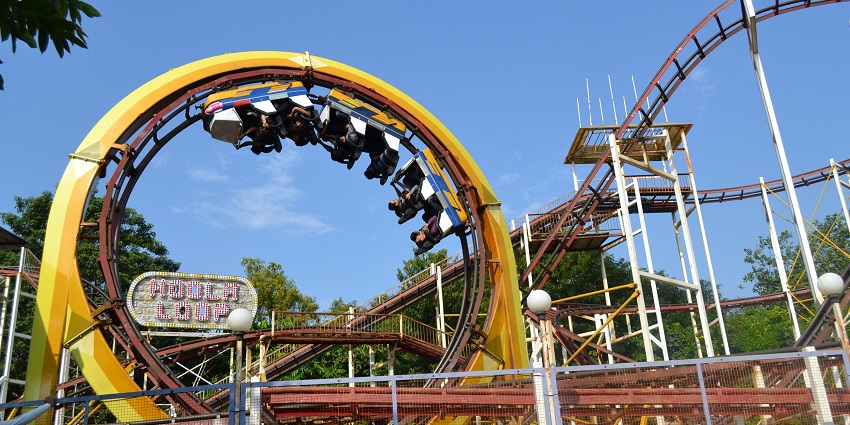 A roller coaster with a yellow loop, cars upside down, at the Essel World in Mumbai