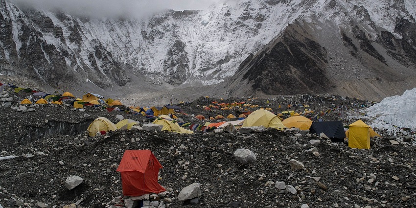 An image showing Mount Everest Base Camp with rugged terrain and snow-covered peaks.