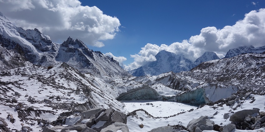 A view of Mount Everest Base full of rocks covered with snow during December.
