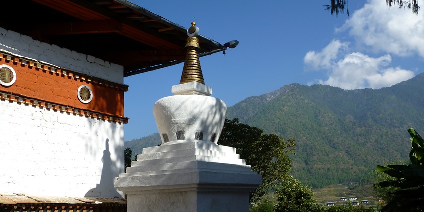 An image of a white stupa with a golden spire at the Kyichu Lhakhang Temple - one of the offbeat things to do in Paro