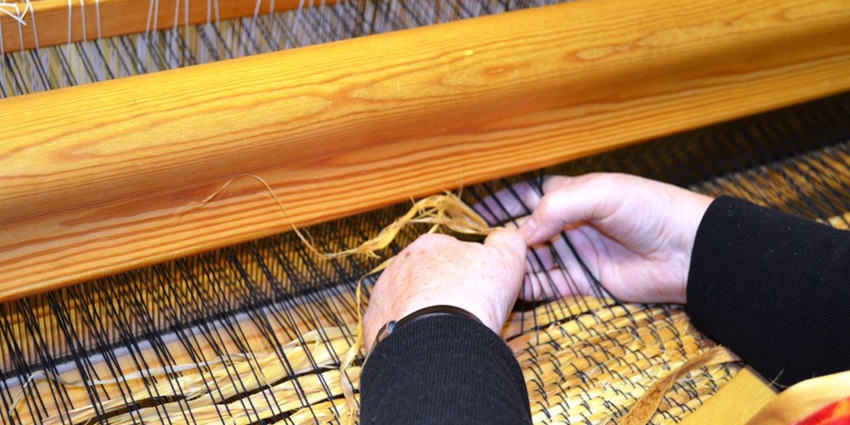 Close up view of a weaving machine offering a cultural experience