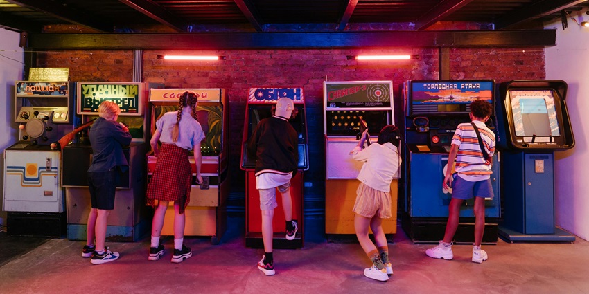 Image of a group of people playing on the gaming arcade in entertainment zones at Penang airport