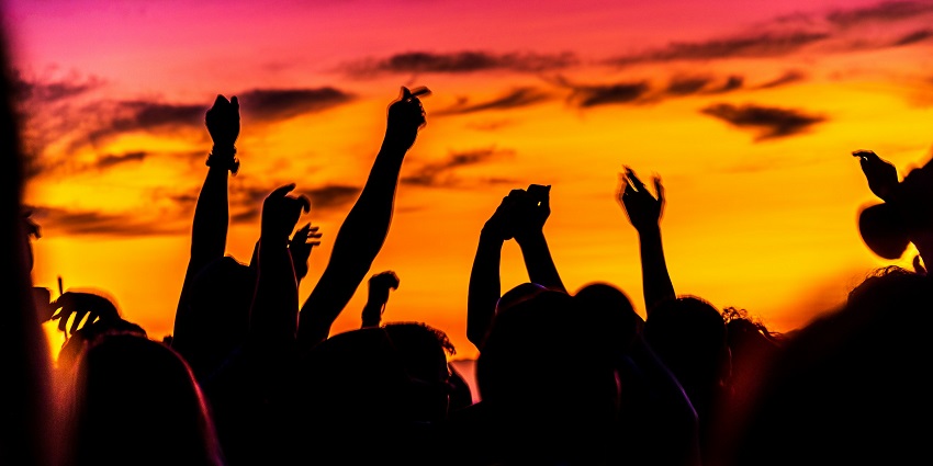 A glimpse of people partying on a serene tropical heaven with a dramatic skyline.