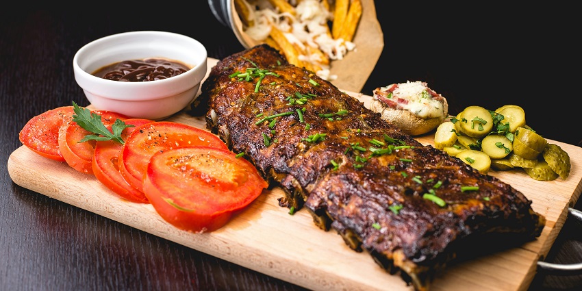 Traditional Athens dishes are being served with salads, grilled meats, and bread.