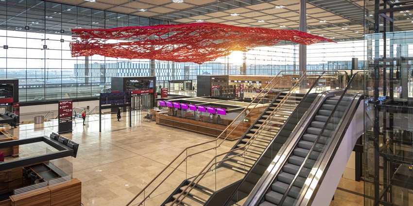 Terminal one of the aviation landmark of the area with escalators and a red carpet above.