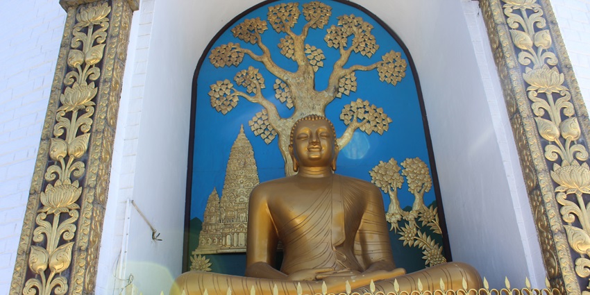 An inside view of the Buddha Stupa Nepal featuring a majestic statue of Buddha.