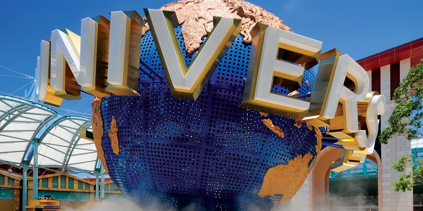 Iconic rotating globe at the Universal Studios Singapore under clear blue skies.