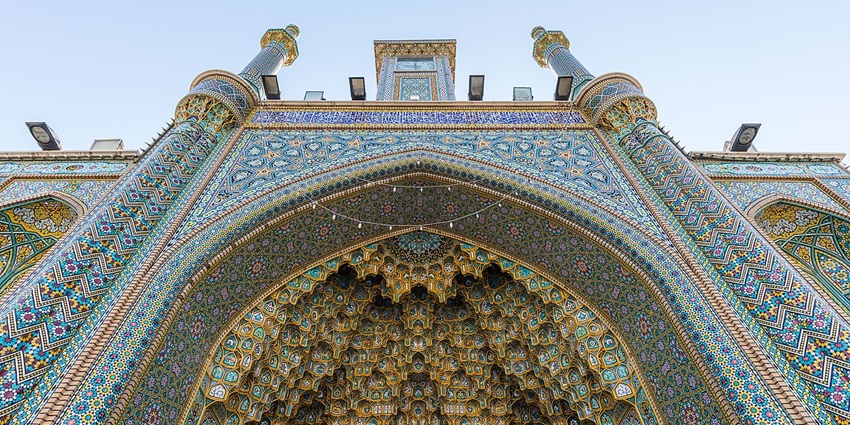 The beautiful golden dome and minarets of Fatima Masumeh Shrine, a famous Shia mosque in Qom, Iran.