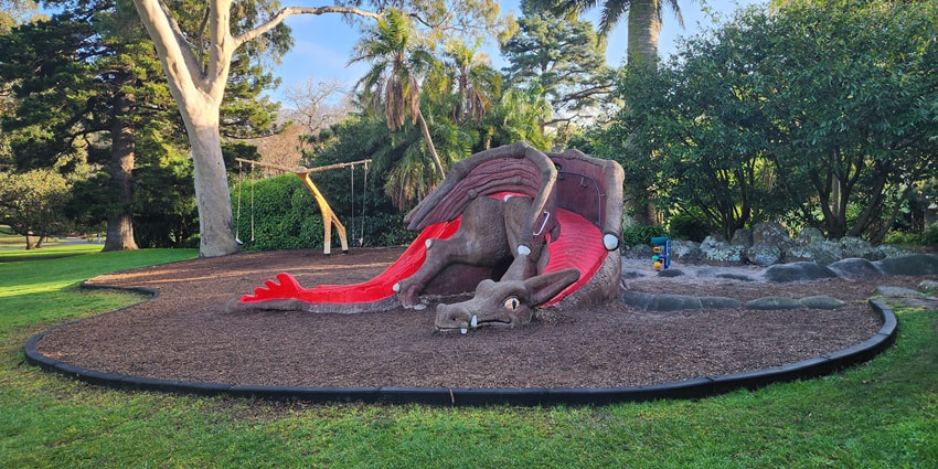 Fitzroy Gardens Playground, featuring play structures and greenery.