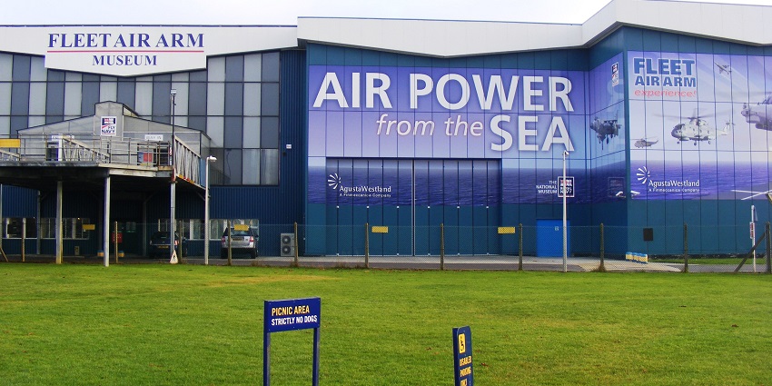 An image of the Fleet Air Arm Museum exterior with banners, and Royal Navy signs, one of the important Naval Aviation Museums in the world.